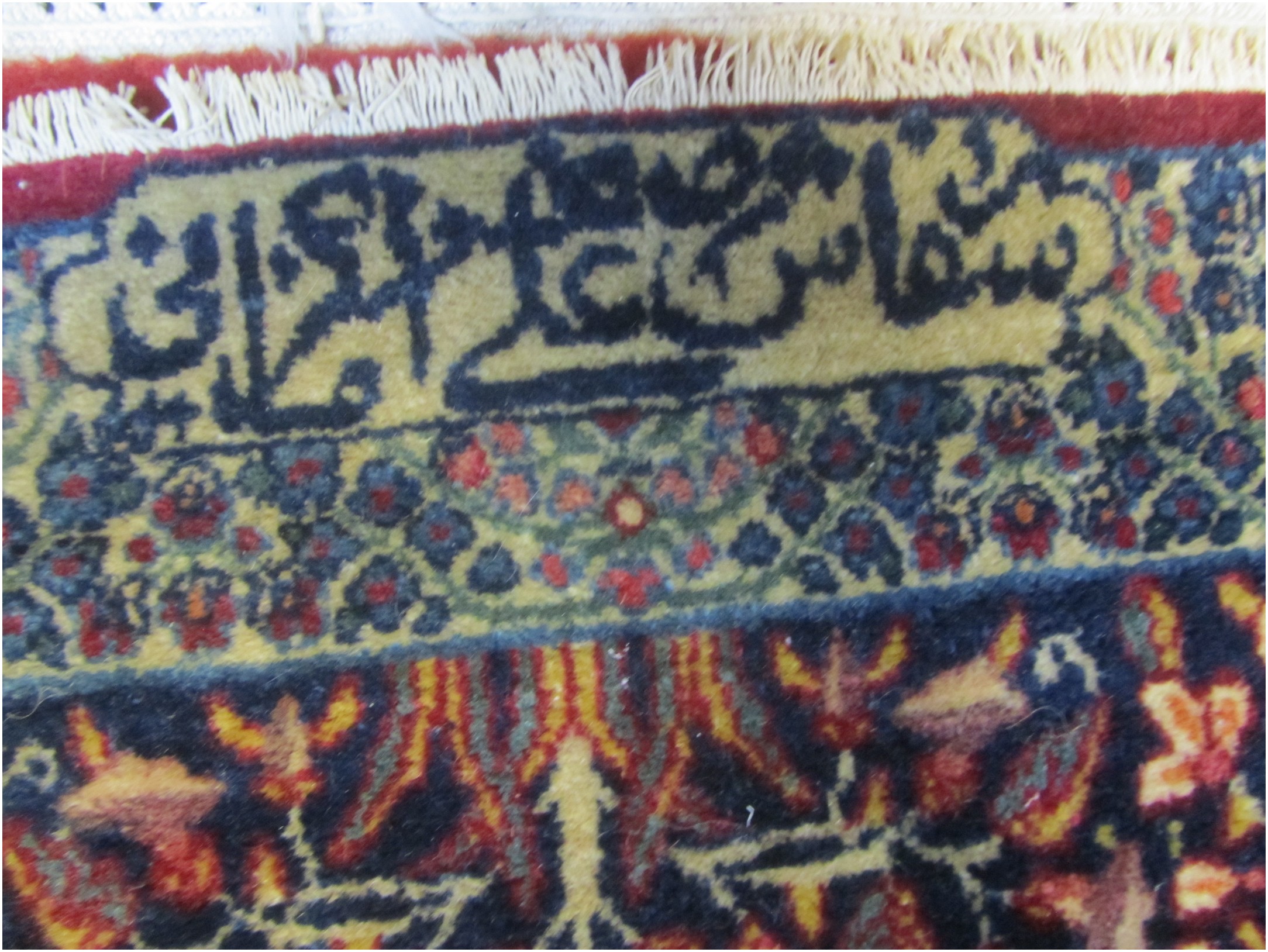 the second signature is transliterated as Sefaresheh Ali Asghar Kermani, meaning Commissioned by Ali Asghar Kermani.